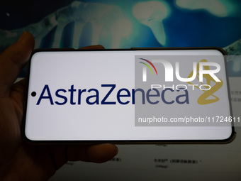 The corporate logo and official website of AstraZeneca are displayed in Shanghai, China, on October 31, 2024. (