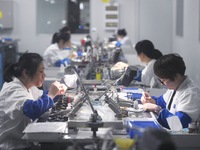 Employees process medical endoscope lenses at the production workshop of Hangzhou HAoke Optoelectronic Instrument Co., LTD., located in Suoq...