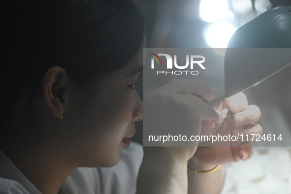 Employees process medical endoscope lenses at the production workshop of Hangzhou HAoke Optoelectronic Instrument Co., LTD., located in Suoq...