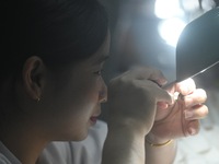 Employees process medical endoscope lenses at the production workshop of Hangzhou HAoke Optoelectronic Instrument Co., LTD., located in Suoq...