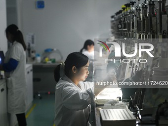 Employees process medical endoscope lenses at the production workshop of Hangzhou HAoke Optoelectronic Instrument Co., LTD., located in Suoq...