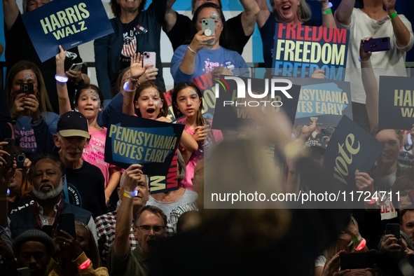 Young girls react to Vice President Kamala Harris as she waves to the crowd during a get out the vote rally in Harrisburg, PA, on October 30...