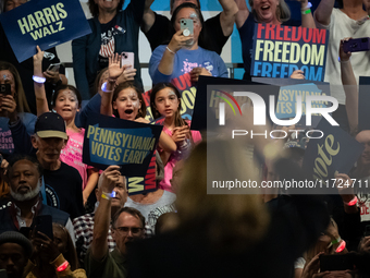 Young girls react to Vice President Kamala Harris as she waves to the crowd during a get out the vote rally in Harrisburg, PA, on October 30...