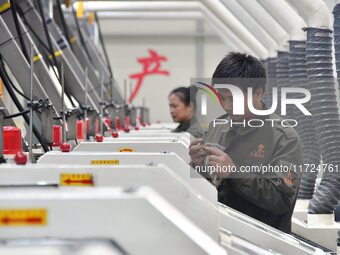 A worker checks product quality at a digital intelligent production workshop at a hardware manufacturing company in Handan, China, on Octobe...