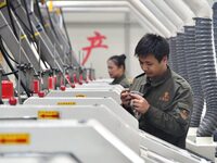 A worker checks product quality at a digital intelligent production workshop at a hardware manufacturing company in Handan, China, on Octobe...