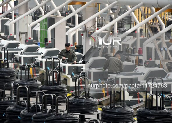 A worker checks equipment operation at a digital intelligent production workshop at a hardware manufacturing company in Handan, China, on Oc...