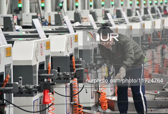 A worker works in a digital intelligent production workshop at a hardware manufacturing company in Handan, China, on October 30, 2024. 