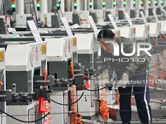 A worker works in a digital intelligent production workshop at a hardware manufacturing company in Handan, China, on October 30, 2024. (