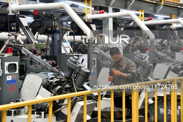 A worker produces drill tail wire for export overseas in a digital intelligent production workshop at a hardware manufacturing company in Ha...