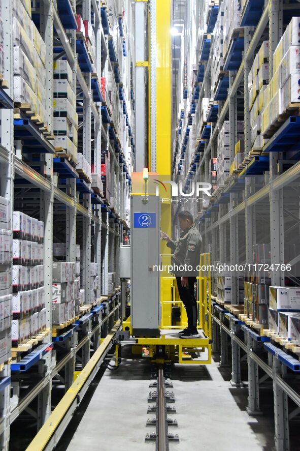 A worker loads and unloads goods at a smart storage workshop at a hardware manufacturing company in Handan, China, on October 30, 2024. 