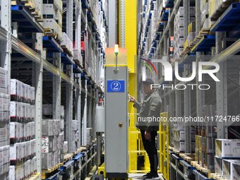 A worker loads and unloads goods at a smart storage workshop at a hardware manufacturing company in Handan, China, on October 30, 2024. (