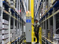 A worker loads and unloads goods at a smart storage workshop at a hardware manufacturing company in Handan, China, on October 30, 2024. (