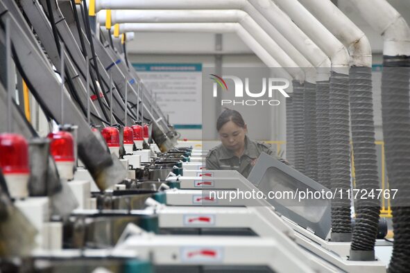 A worker works in a digital intelligent production workshop at a hardware manufacturing company in Handan, China, on October 30, 2024. 