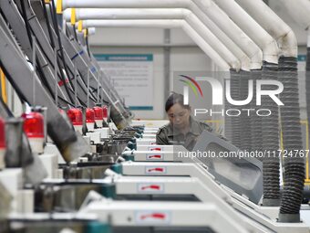 A worker works in a digital intelligent production workshop at a hardware manufacturing company in Handan, China, on October 30, 2024. (