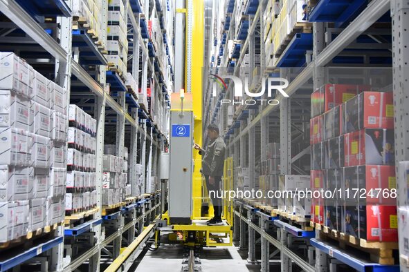 A worker loads and unloads goods at a smart storage workshop at a hardware manufacturing company in Handan, China, on October 30, 2024. 