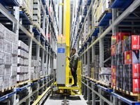 A worker loads and unloads goods at a smart storage workshop at a hardware manufacturing company in Handan, China, on October 30, 2024. (