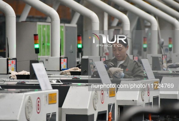 A worker works in a digital intelligent production workshop at a hardware manufacturing company in Handan, China, on October 30, 2024. 