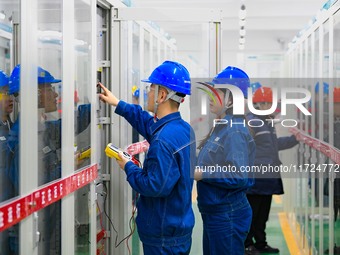 Operation and maintenance personnel work at the Shengli Substation of the Zhangbei-Shengli 1000kV UHV AC project in Xilingol League, Inner M...