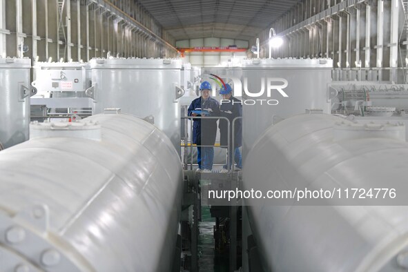 Operation and maintenance personnel check transmission equipment at the Shengli Substation of the Zhangbei-Shengli 1000kV UHV AC project in...