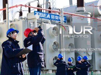 Operation and maintenance personnel check transmission equipment at the Shengli Substation of the Zhangbei-Shengli 1000kV UHV AC project in...