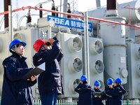 Operation and maintenance personnel check transmission equipment at the Shengli Substation of the Zhangbei-Shengli 1000kV UHV AC project in...