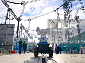 Operation and maintenance personnel check transmission equipment at the Shengli Substation of the Zhangbei-Shengli 1000kV UHV AC project in...