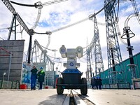 Operation and maintenance personnel check transmission equipment at the Shengli Substation of the Zhangbei-Shengli 1000kV UHV AC project in...