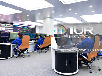 Operation and maintenance personnel work in the centralized control room of Shengli Substation of the Zhangbei-Shengli 1000kV UHV AC project...