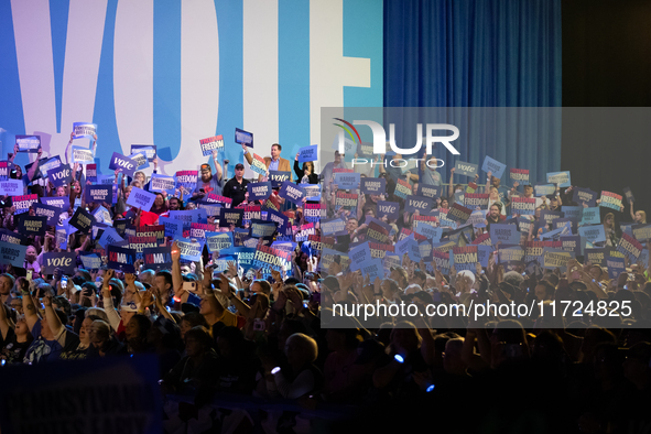 People cheer Vice President Kamala Harris while she speaks at a get out the vote rally in Harrisburg, PA, on October 30, 2024.  Harris and h...