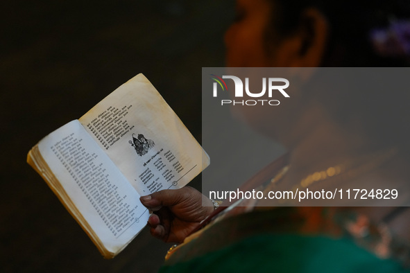 A Hindu devotee reads the Hindu religious book at the Sri Ponnambala Vaneswarar Hindu temple in Colombo, Sri Lanka, on October 31, 2024. Diw...