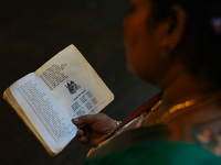 A Hindu devotee reads the Hindu religious book at the Sri Ponnambala Vaneswarar Hindu temple in Colombo, Sri Lanka, on October 31, 2024. Diw...