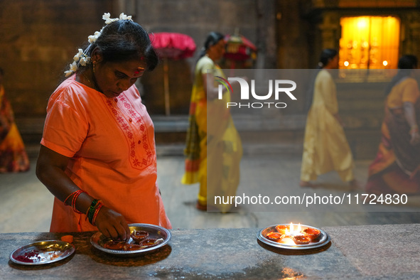 A Hindu devotee lights the oil lamps to celebrate Diwali at the Sri Ponnambala Vaneswarar Hindu temple in Colombo, Sri Lanka, on October 31,...