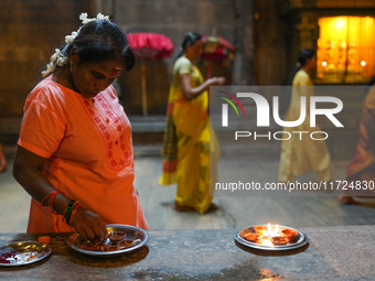 A Hindu devotee lights the oil lamps to celebrate Diwali at the Sri Ponnambala Vaneswarar Hindu temple in Colombo, Sri Lanka, on October 31,...