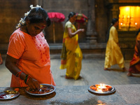 A Hindu devotee lights the oil lamps to celebrate Diwali at the Sri Ponnambala Vaneswarar Hindu temple in Colombo, Sri Lanka, on October 31,...