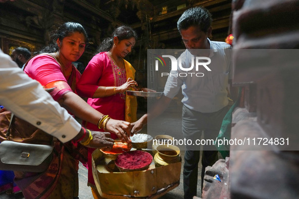 Hindu devotees take the holy ash, known as Vibhuti, Bhasma (Sanskrit), or Thiruneeru (Tamil), to celebrate Diwali at the Sri Ponnambala Vane...