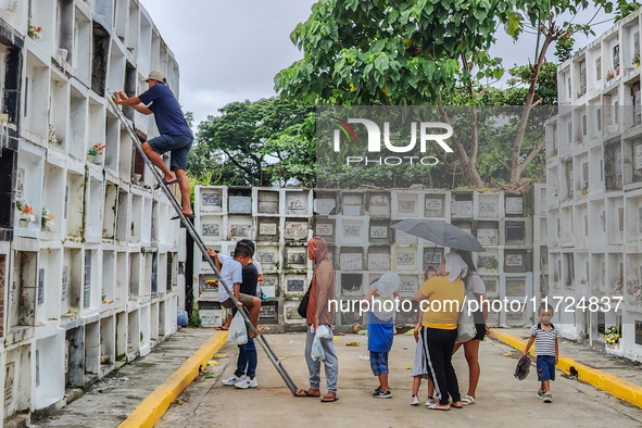 Filipinos visit the graves of their loved ones in Rizal, Philippines, on October 31, 2024. Undas, a unique occasion observed by Filipinos, d...