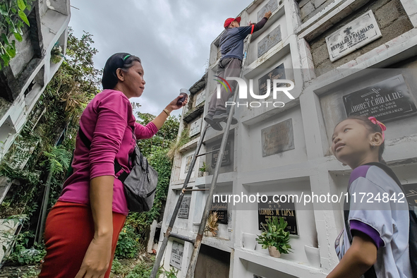 Filipinos visit the graves of their loved ones in Rizal, Philippines, on October 31, 2024. Undas, a unique occasion observed by Filipinos, d...