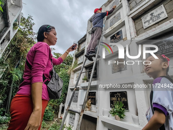 Filipinos visit the graves of their loved ones in Rizal, Philippines, on October 31, 2024. Undas, a unique occasion observed by Filipinos, d...