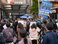 Around 20 members of the Korean University Students' Progressive Union and citizens protest at the People Power Party's central office in Ye...