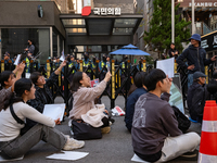 Around 20 members of the Korean University Students' Progressive Union and citizens protest at the People Power Party's central office in Ye...