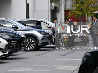 A salesperson prepares to deliver a car to a customer at a BYD 4S store in Nanjing, China, on October 31, 2024. On October 31, 2024, BYD ann...