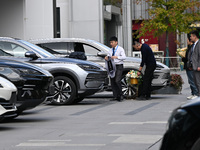 A salesperson prepares to deliver a car to a customer at a BYD 4S store in Nanjing, China, on October 31, 2024. On October 31, 2024, BYD ann...