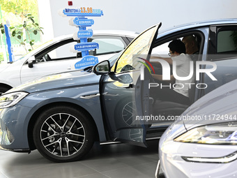 A customer experiences a BYD car at a BYD 4S store in Nanjing, China, on October 31, 2024. On October 31, 2024, BYD announces that its opera...