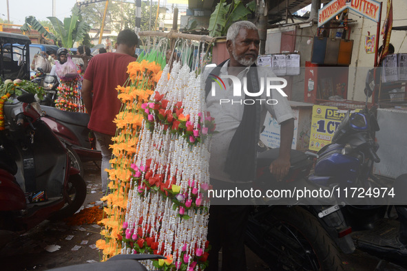 A seller of decorative items waits for customers at the roadside for home decorations on the occasion of 'Diwali', the Hindu festival of lig...