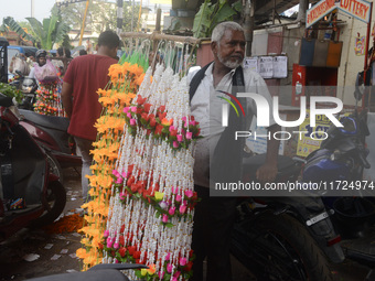 A seller of decorative items waits for customers at the roadside for home decorations on the occasion of 'Diwali', the Hindu festival of lig...