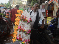 A seller of decorative items waits for customers at the roadside for home decorations on the occasion of 'Diwali', the Hindu festival of lig...