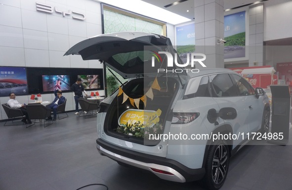 Customers buy a BYD electric car at a BYD store in Hangzhou, China, on October 31, 2024. 