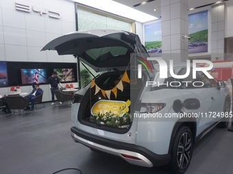 Customers buy a BYD electric car at a BYD store in Hangzhou, China, on October 31, 2024. (