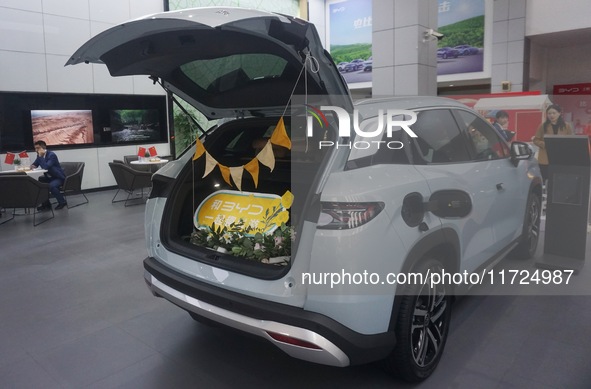 Customers buy a BYD electric car at a BYD store in Hangzhou, China, on October 31, 2024. 