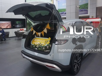 Customers buy a BYD electric car at a BYD store in Hangzhou, China, on October 31, 2024. (